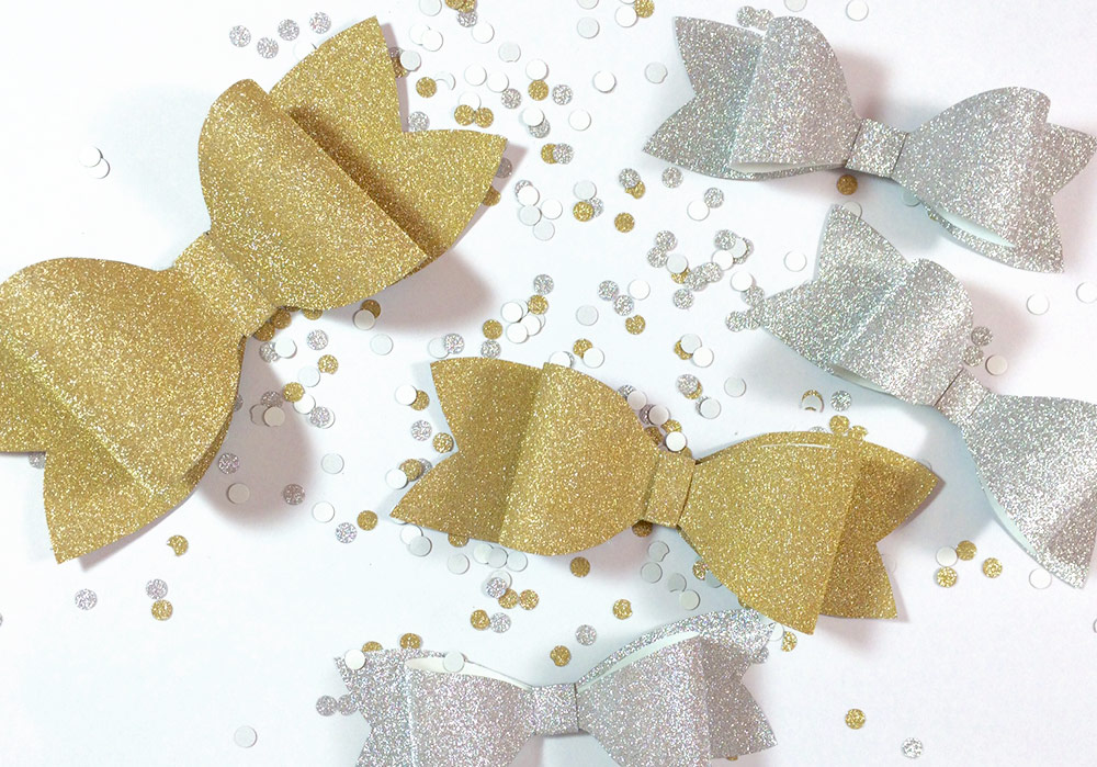 DIY silver and gold glitter paper bows by Allie & Elle. Step by step instructions in post