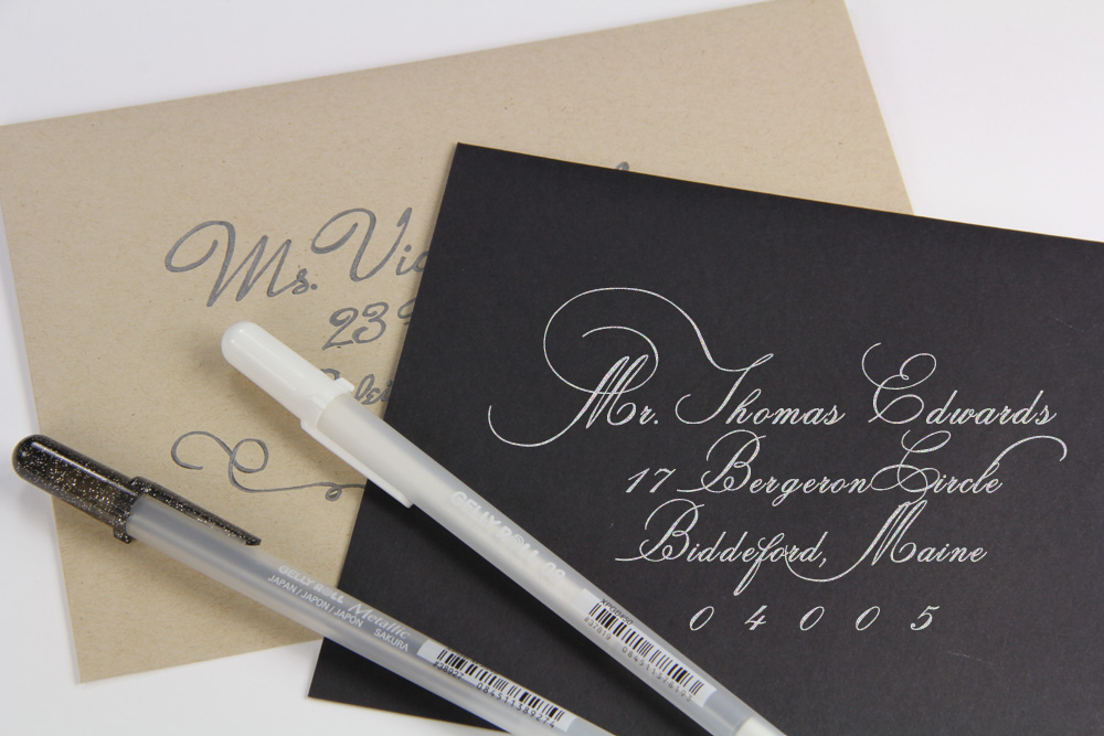 black and kraft brown envelopes addressed with calligraphy