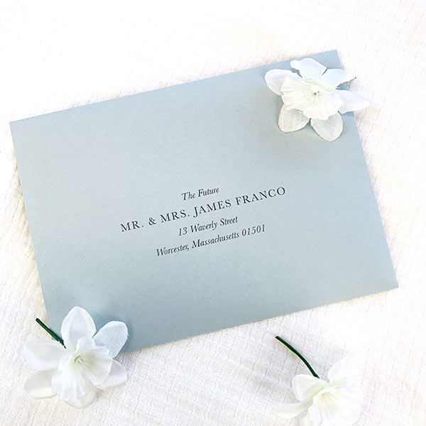 Dusty blue wedding envelope with blue printing for addresses