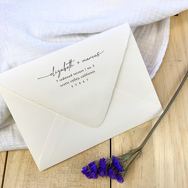 Cream colored deckled edge envelopes with digital calligraphy return address