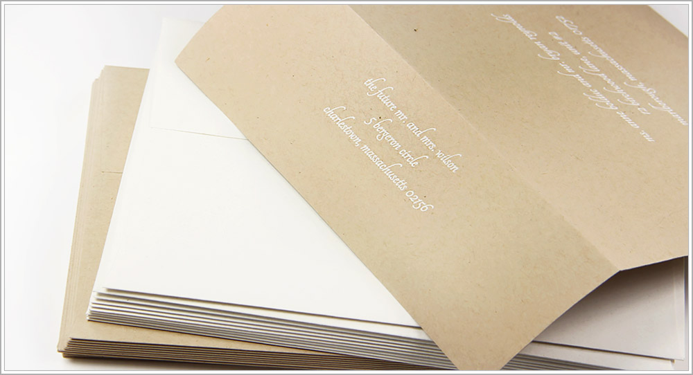 White ink printed on Desert Storm kraft envelopes in white ink - Tangerine font