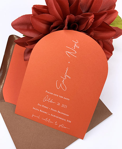 Orange and terracotta arch shaped save the date printed in white by LCI Paper