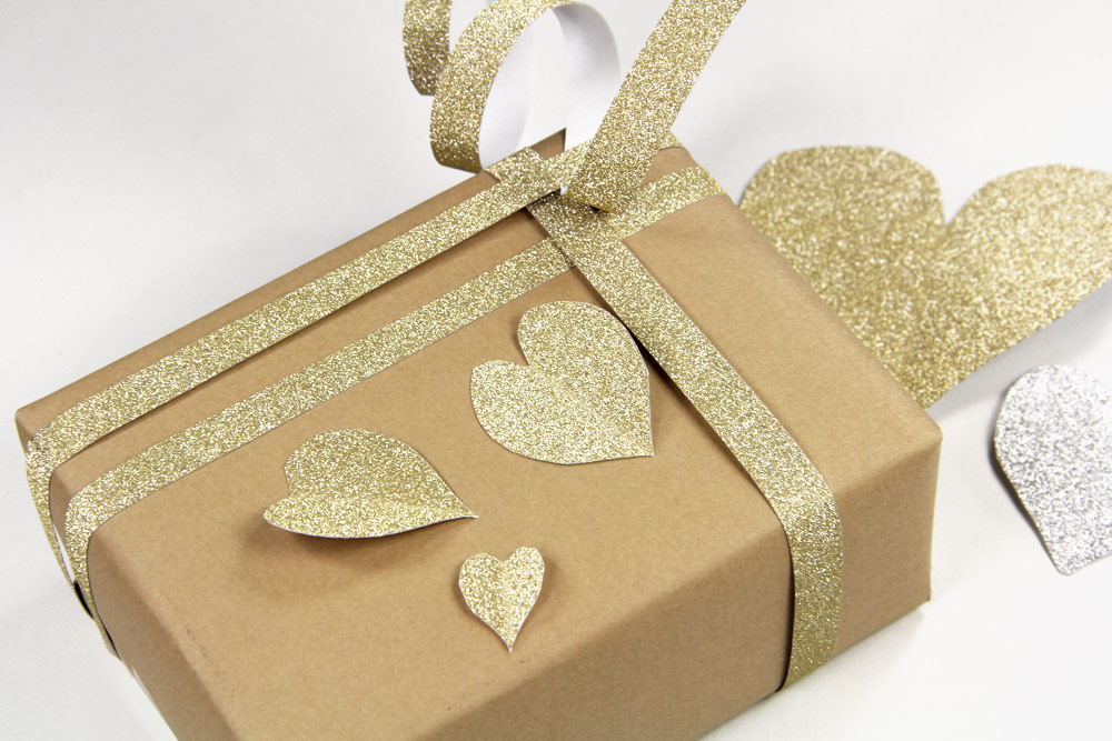 Kraft paper wrapped present with MirriSPARKLE glitter paper heart and band embellishments