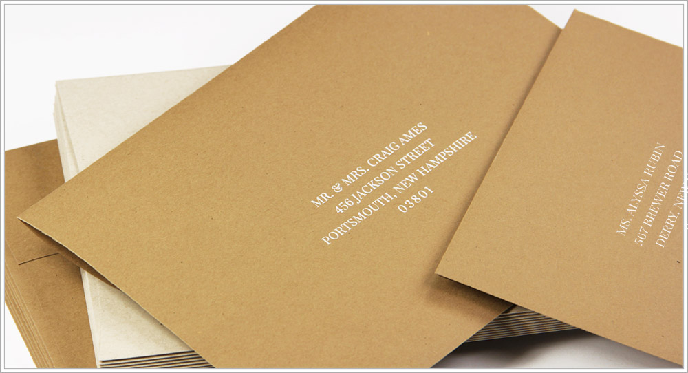 Matching kraft envelopes printed with white ink in Playfair Display font