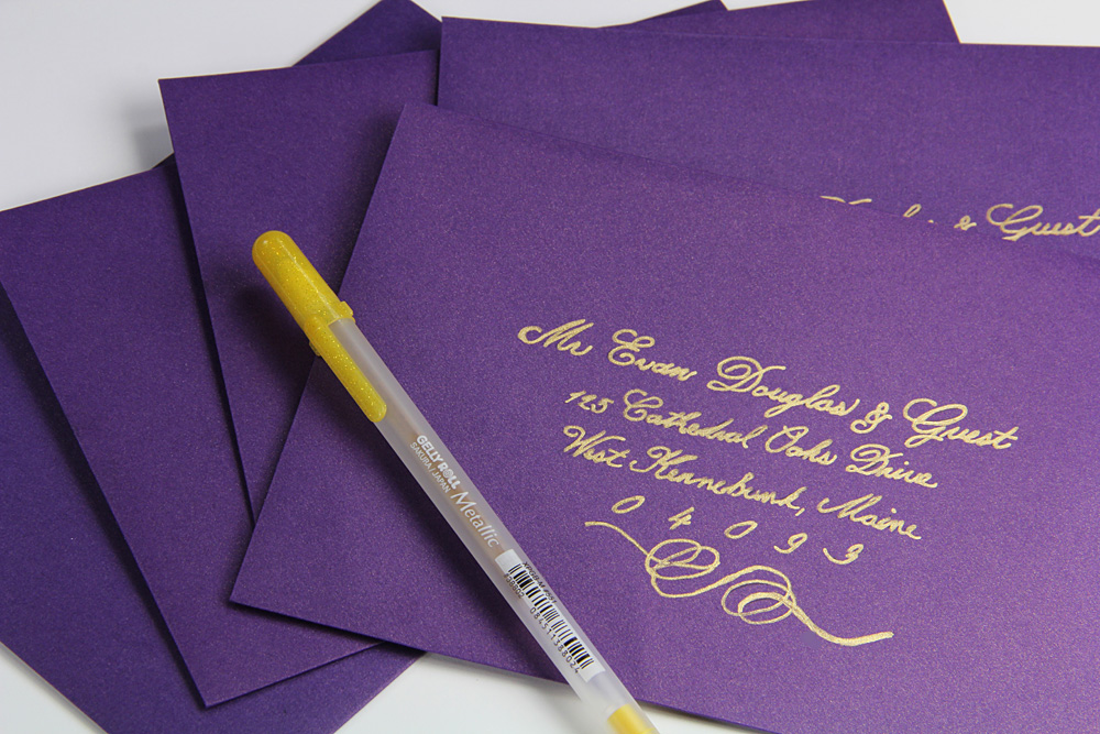 purple metallic envelopes addressed with gold ink