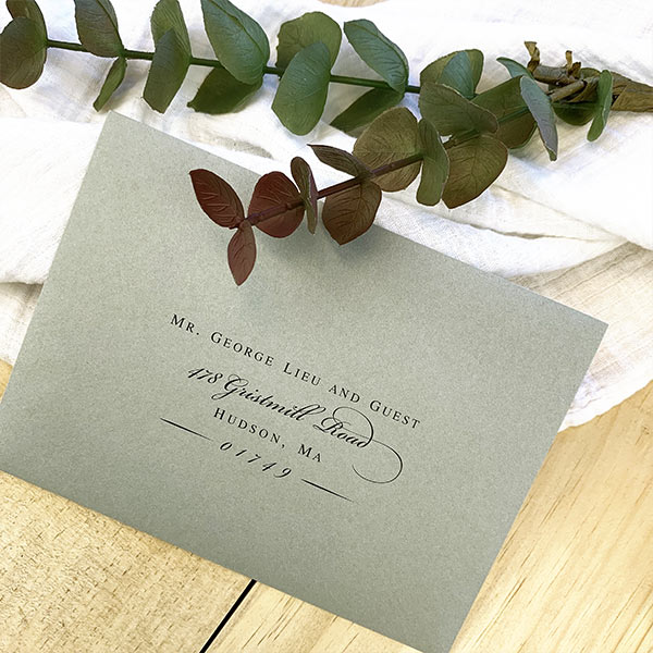 Sage green wedding envelopes with printed addresses