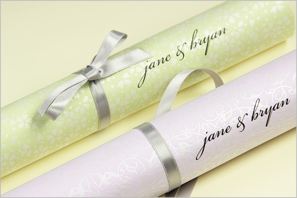 scroll programs made with pearlized paper tied with ribbon