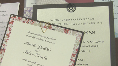Two invitations embellished with spiral clips