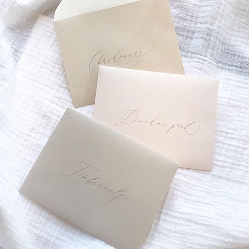 Light gray printing on light gray, blush and taupe envelopes