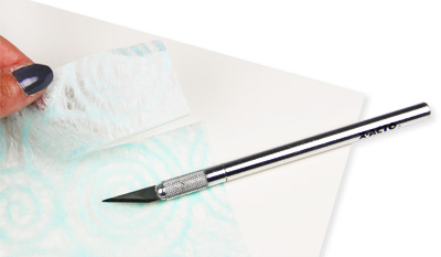 tissue paper cut with exacto knife